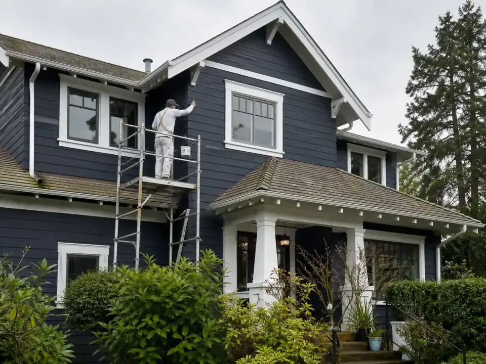 Dark blue craftsman home with crisp white painted trim